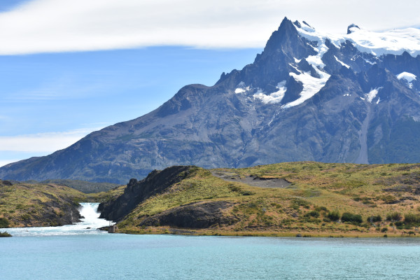 lake with waterfall while hiking Torres del Paine